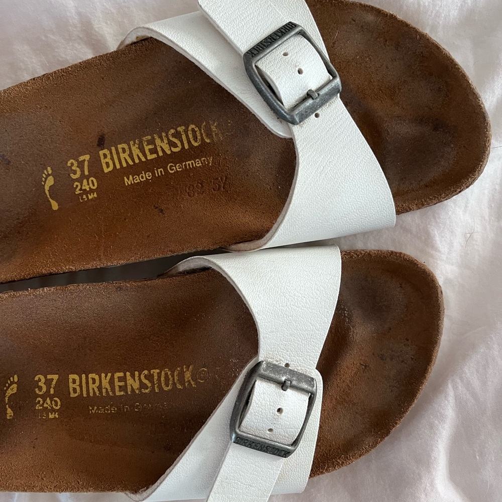 White Birkenstock sandals.